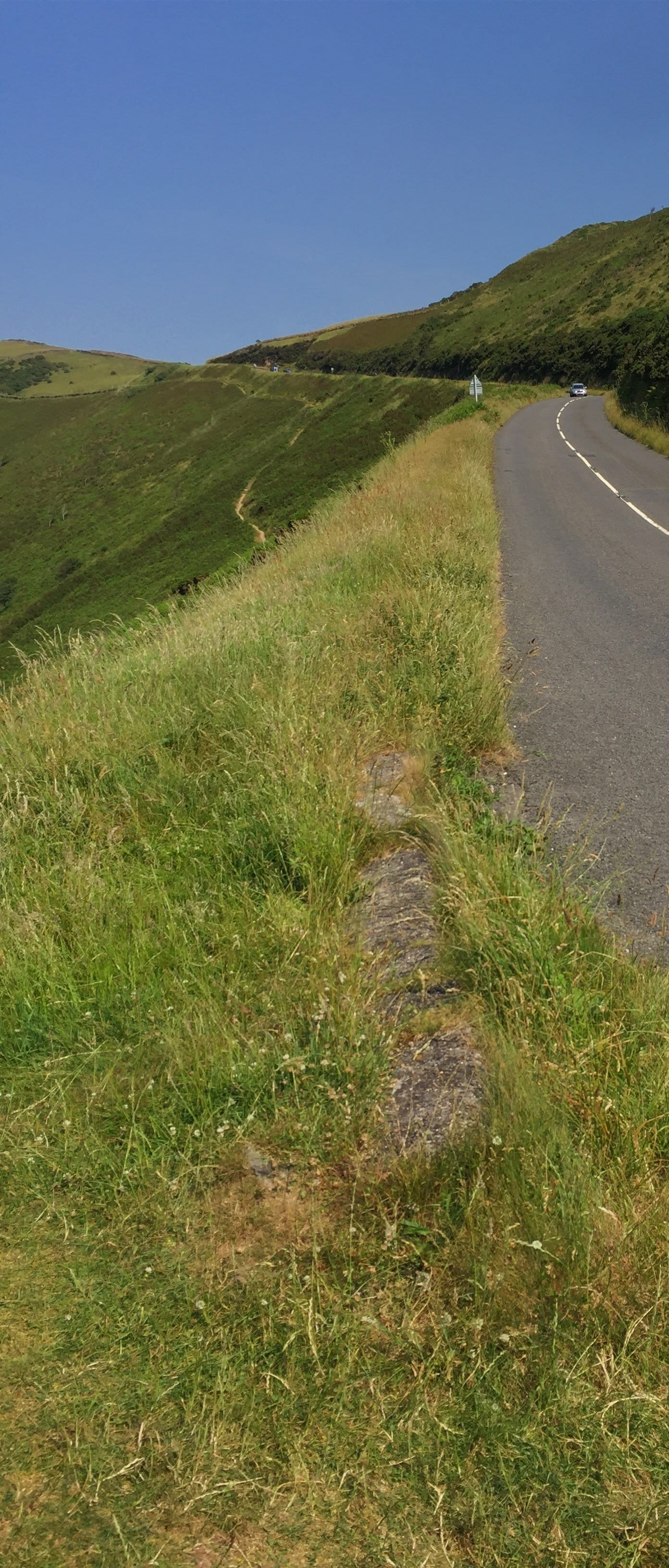 Winding road through rolling green hills, Lynton