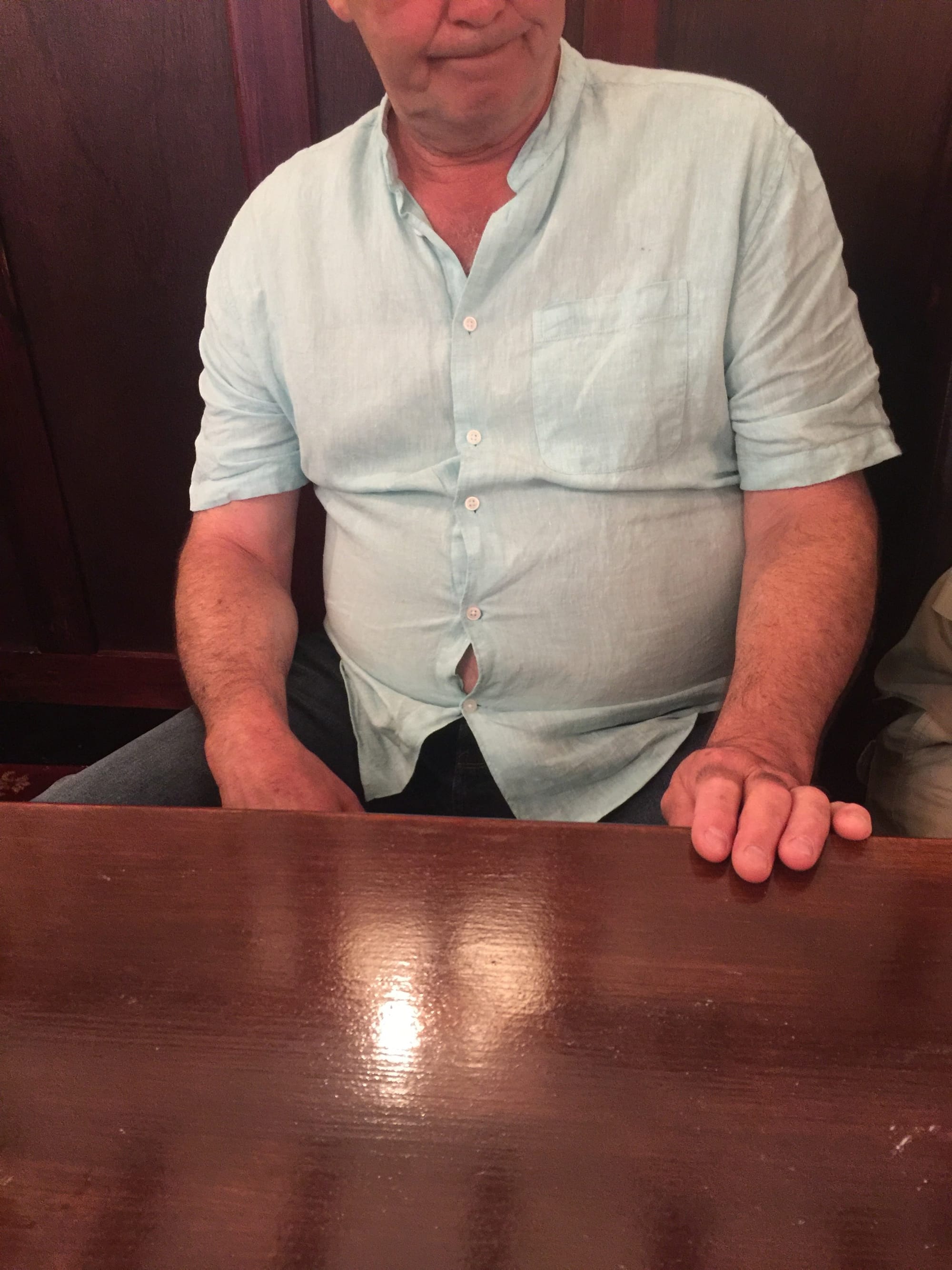 Man at table in Alcombe, England
