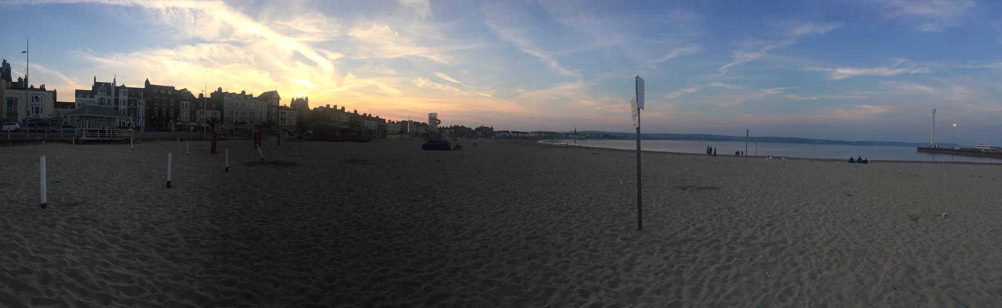 Sunset beach at Melcombe Regis with historic buildings